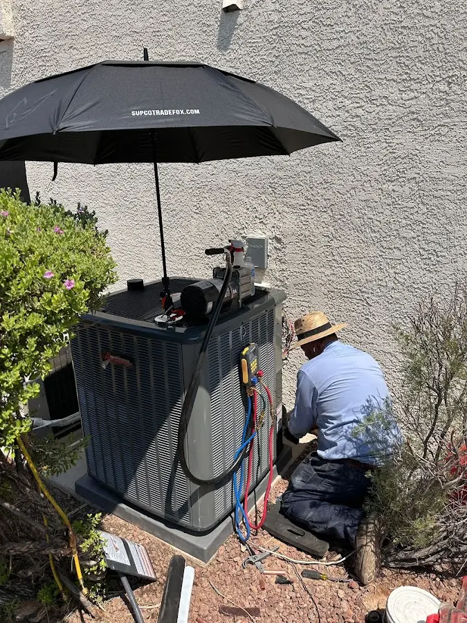 HVAC technician performing outdoor AC maintenance in Thompson's Station